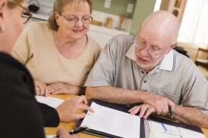 Senior couple filling out papers